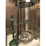 A black metal cast four tier plant stand together with a green metal mug rack