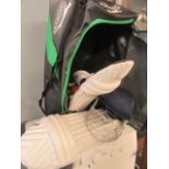 A cricket bag containing cricket equipment to include pads, helmet, gloves etc.