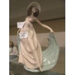 A Lladro figurine of young lady with flowing dress wearing hat