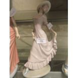 A Nao figurine of young girl holding skirt at back