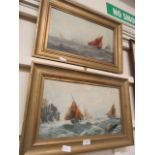 Two late Victorian gilt framed oils of sailing boats in stormy seas