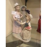 A Nao figurine of two young girls together with a Nao figurine of young boy with a lamb
