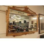 A reproduction ornate gilt framed bevel glass wall mirror