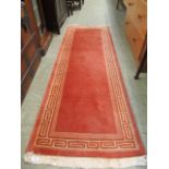 A peach coloured Chinese style rectangular rug