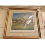 A framed and glazed limited edition print of horse racing signed in pencil