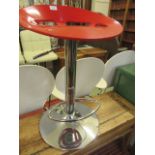 A modern chrome and red stool