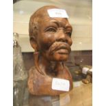 An African carved wooden bust of a man's head