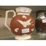 A Victorian Wedgwood style brown and white glazed jug
