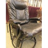 A mid-20th century black metal and black fabric swivel reclining chair