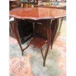 An Edwardian walnut scalloped sided occasional table with under tier
