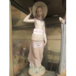 A Lladro figuring of young lady with hat