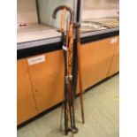 A collection of walking sticks and riding crops