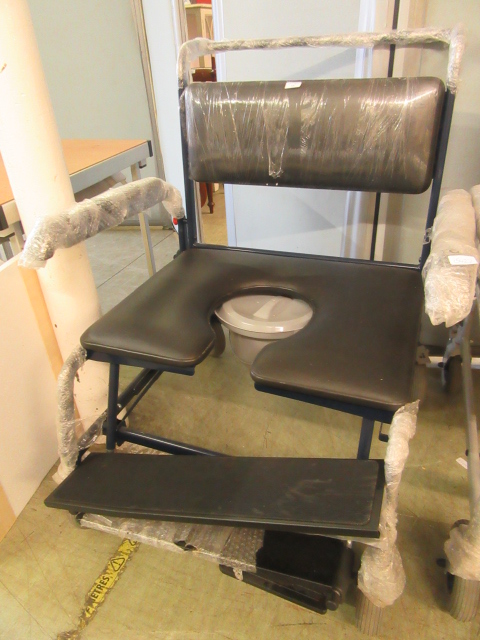 A heavy duty four wheeled commode chair