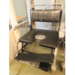A heavy duty four wheeled commode chair