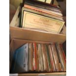 Two boxes of assorted records to include 45rpm records and LPs