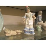 A Lladro figurine of young girl with blue dress together with a Lladro figurine of sleeping baby