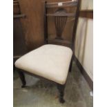 An Edwardian walnut framed nursing chair