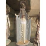 A Lladro figurine of young lady with flowing gown wearing hat