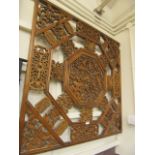 An oriental hardwood carved and pierced wall plaque