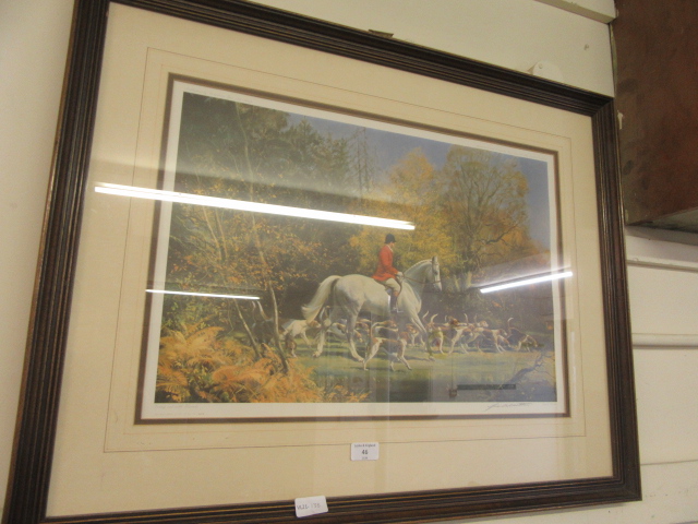 A framed and glazed hunting print signed in pencil