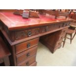 A reproduction oak twin pedestal desk having a tooled leather insert to top