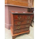 A reproduction flame mahogany chest of two short over three long drawers of small proportions