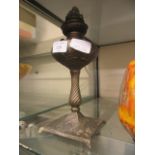 A cast metal paraffin lamp