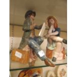 A pair of glazed ceramic models of young boy and girl