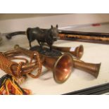 A hunting horn together with two other bugles and a cast model of horse