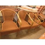 A set of four wicker open armchairs
