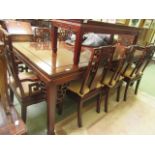 A Chinese hardwood extending dining table having two extra leaves together with a set six standard