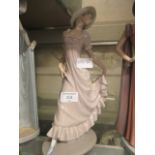 A Nao figurine of young lady with pink dress wearing hat