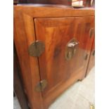An eastern hardwood two door cabinet with brass furniture