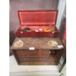 An engineers' cabinet containing an assortment of tools, watch parts,