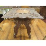 An oriental wooden carved collapsible occasional table