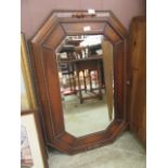 An oak framed mid-20th century bevel glass wall mirror