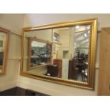 A gilt framed wall mirror