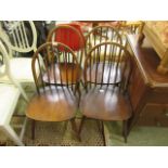 A set of four Ercol spindle back dining chairs