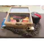An oriental style box containing an assortment of hats, ribbons,