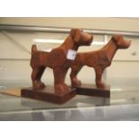 Two carved teak dog book ends