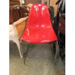 A red PVC and chrome legged chair