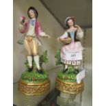 A pair of continental ceramic figures of young gentleman and lady by Martha Budich of Dresden (A/F)