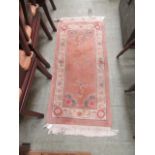 A pink rectangular Chinese style rug