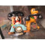 Two mid-20th century Disney novelty telephones one of Goofy the other of Pluto