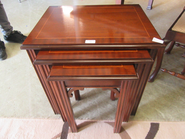 A nest of three modern mahogany tables