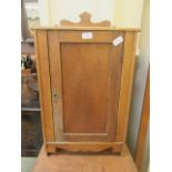 A small single door oak cabinet