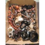 A box containing an assortment of costume jewellery to include necklaces, bracelets,