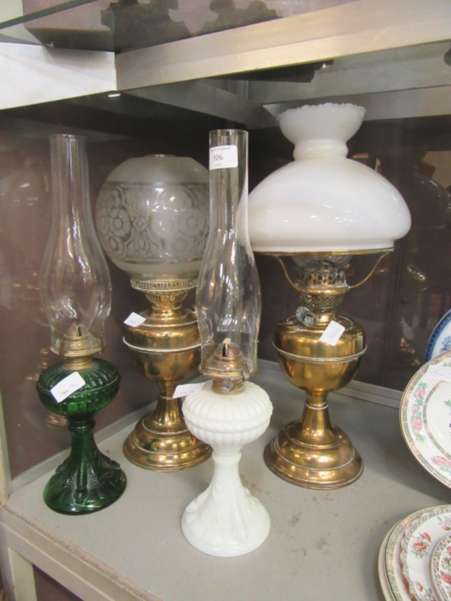 Two brass oil lamps along with two glass oil lamps