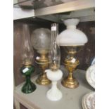 Two brass oil lamps along with two glass oil lamps