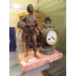 An early 20th century French mantle clock having fisherman next to the movement on marble base